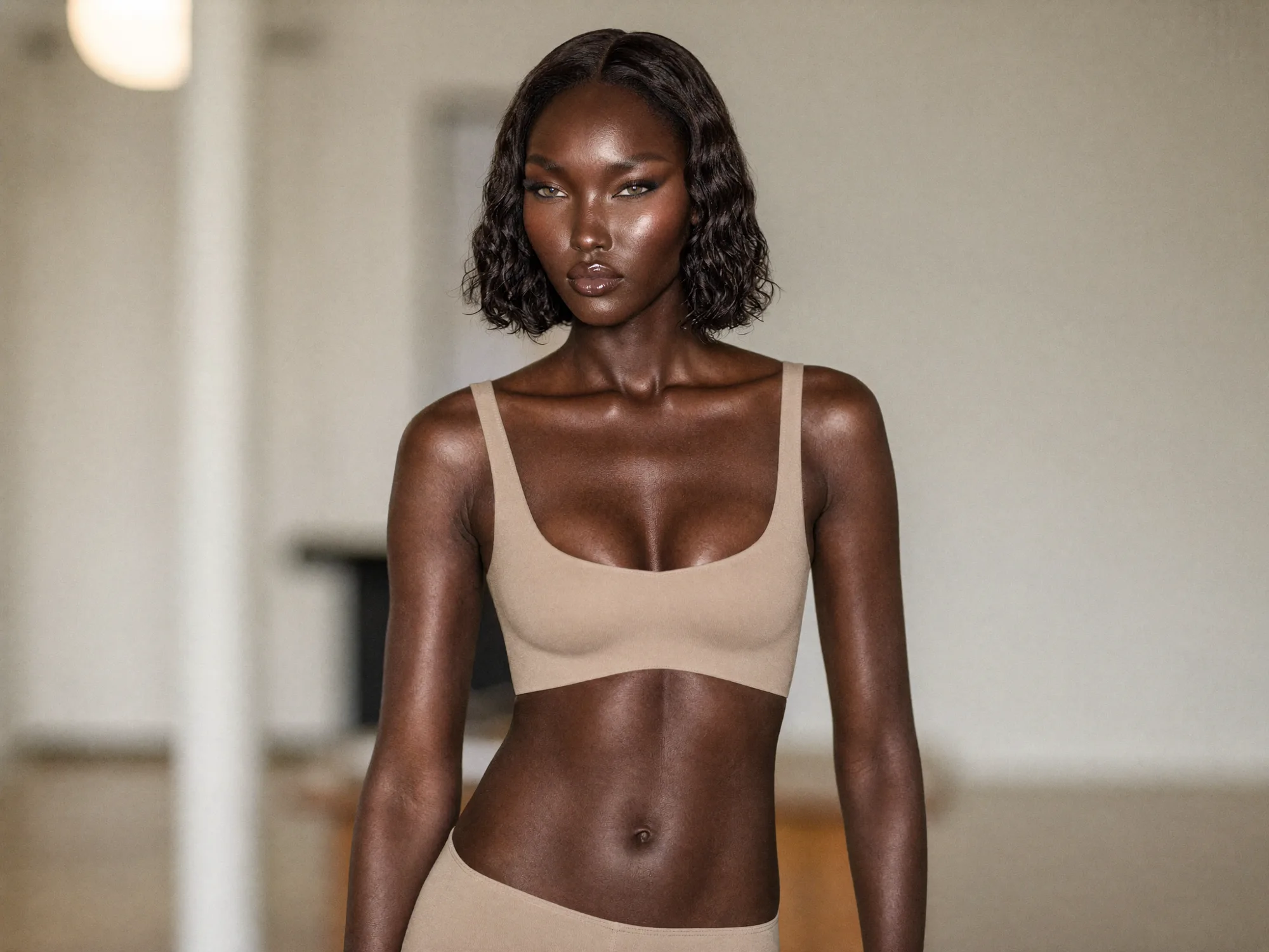 A creator in neutral tones photographed in soft daylight