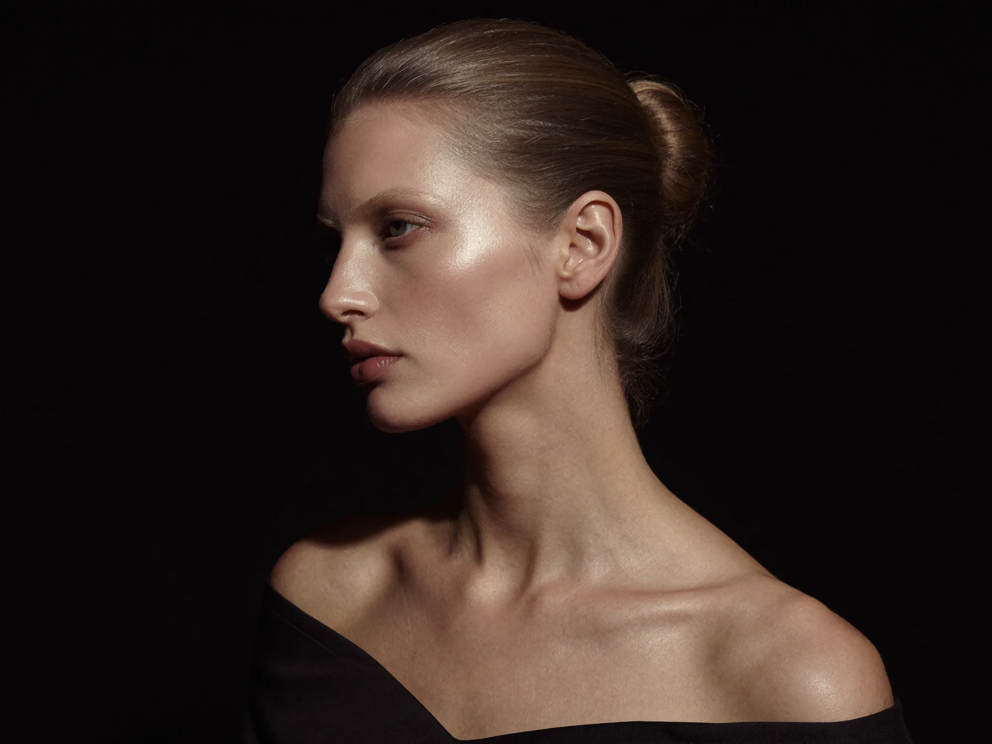 A profile portrait against a black ground in soft sculpted light